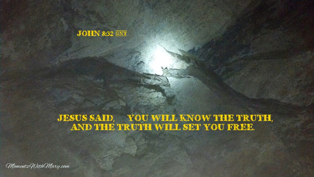 Flashlight illuminates a black fault line inside a dark cave showing a shift in the tectonic plate. Bible verse in yellow reads John 8:32 Jesus said you will know the truth, and the truth will set you free.